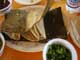 Tacos of Barbacoa which is steamed shredded beef - in this case served on a plate of Maguey leaves